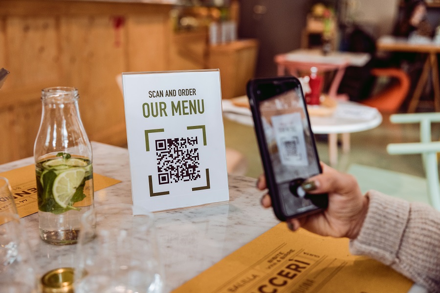 scanning and ordering menu in restaurant with the phone using QR code