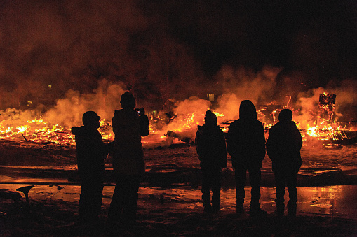 Group of people watching a fire