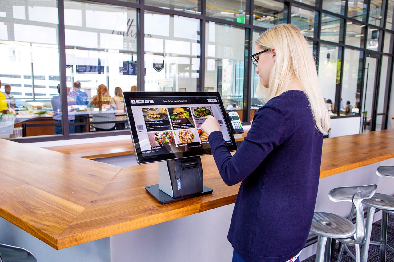 Female woman girl using countertop pos system for restaurant ordering