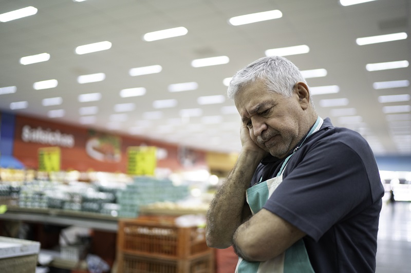 Employee or owner feeling bad at working on supermarket