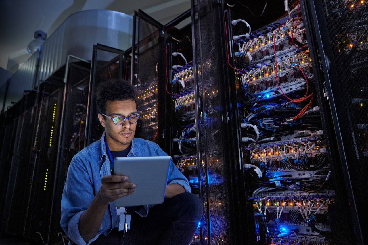 male man technician working on tablet for services on technology and data