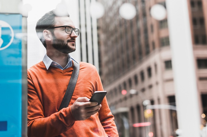 young man in a street with phone