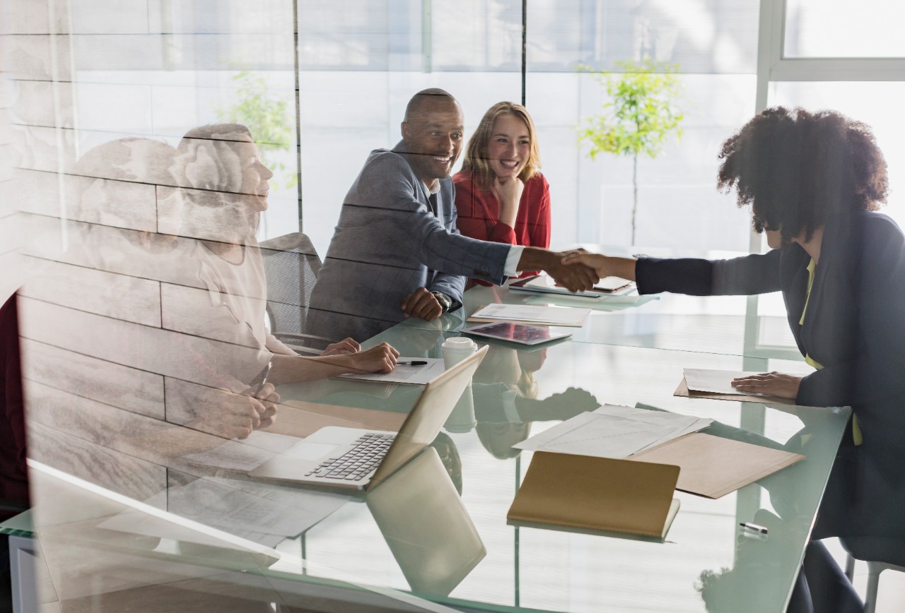 teams of professionals and clients making deals smiling and agreeing