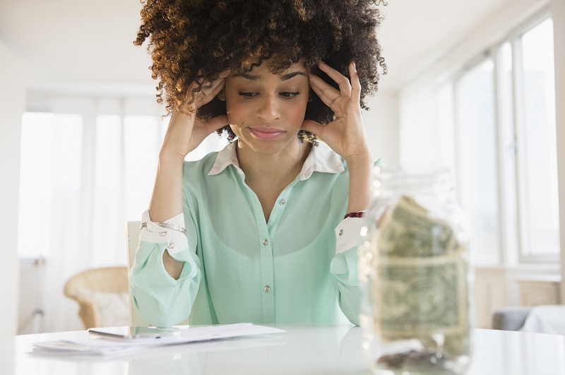 Stressed woman thinking of how to pay bills