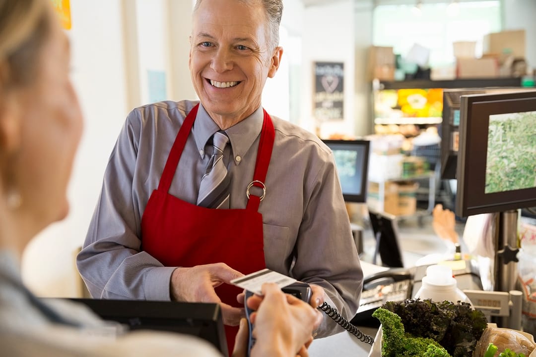 Smiling Man in the Store with Credit Card