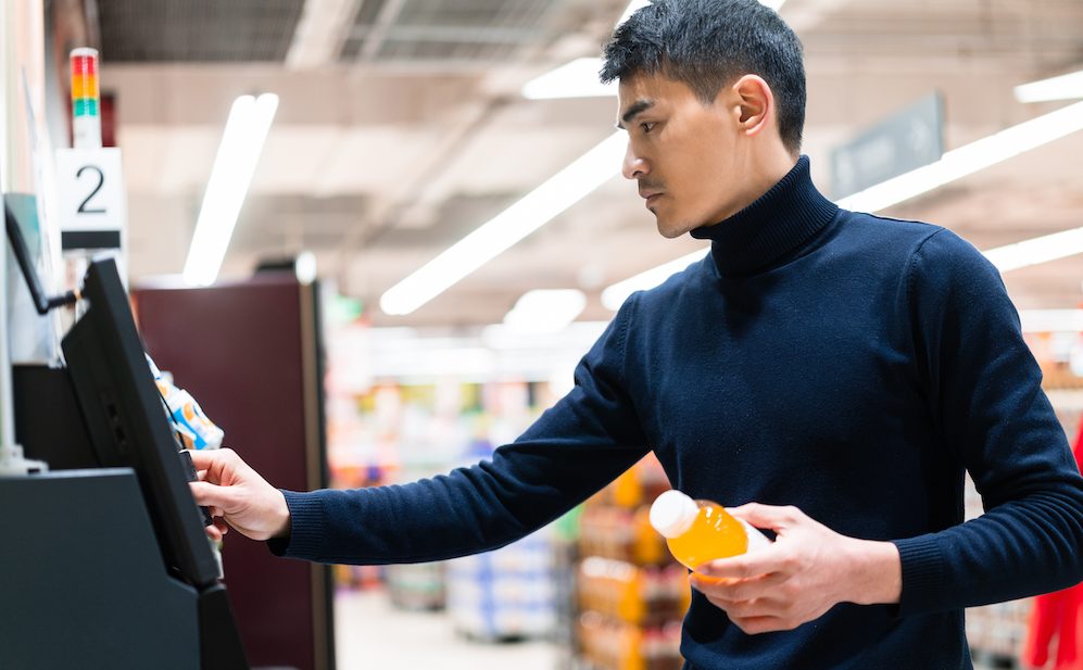 asian man checkout with Self service  in supermarket
